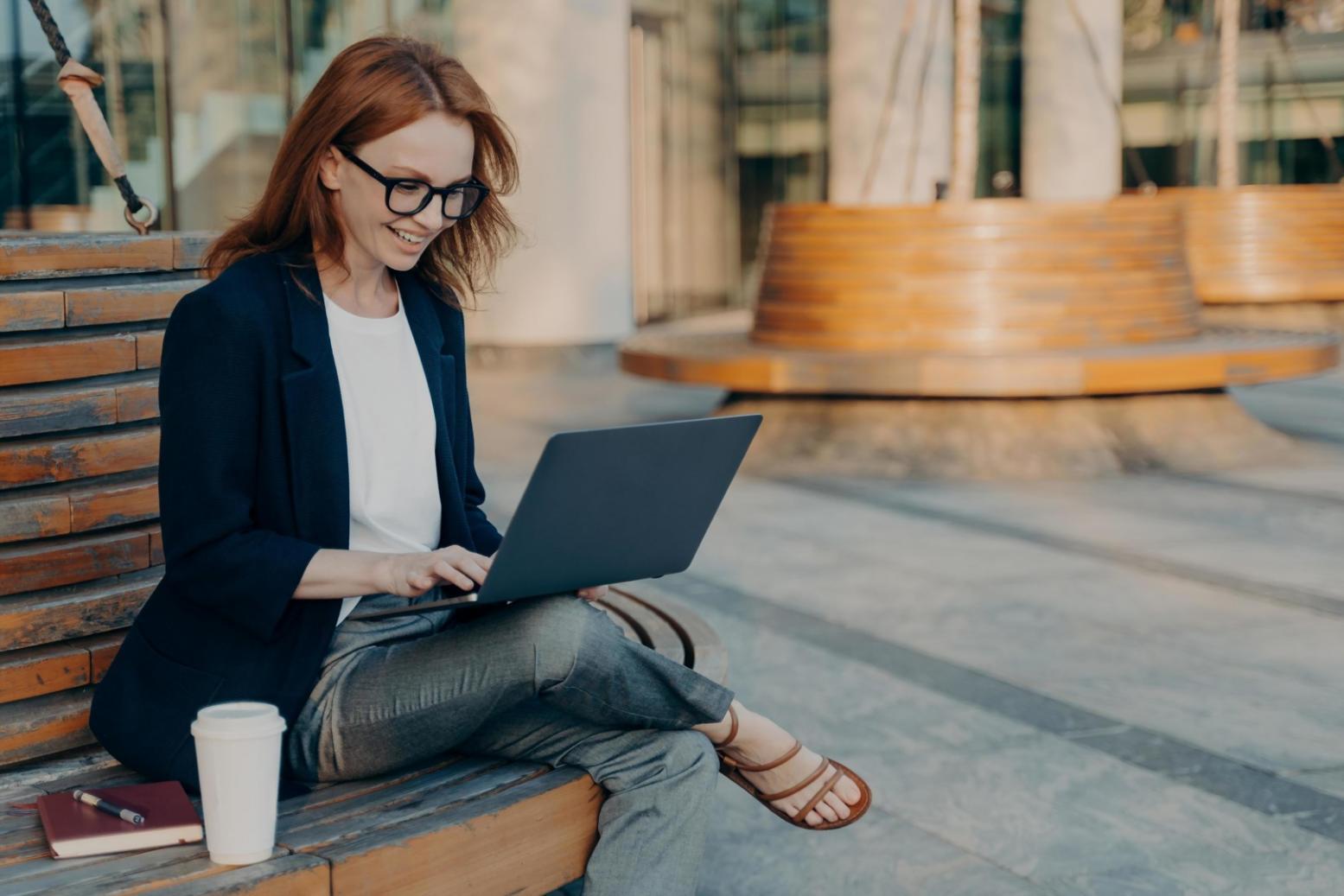 Students collaborating on economic analysis projects in modern learning environment